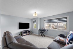 Carpeted flooring, multiple windows with blinds, recessed lighting, and a mounted ceiling fixture - 