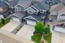 Contemporary two-story exterior with an attached two-car garage, concrete driveway, and front lawn landscaping - 16327 17 Avenue Sw, Edmonton, AB  - Outdoor With Facade 