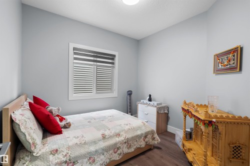 Wood-finish flooring, light gray wall paint, and a window with horizontal blinds - 16327 17 Avenue Sw, Edmonton, AB 