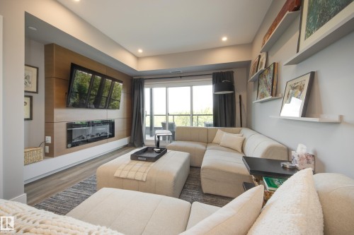 #312 7471 May Cm Nw, Edmonton, AB - Indoor Photo Showing Living Room With Fireplace