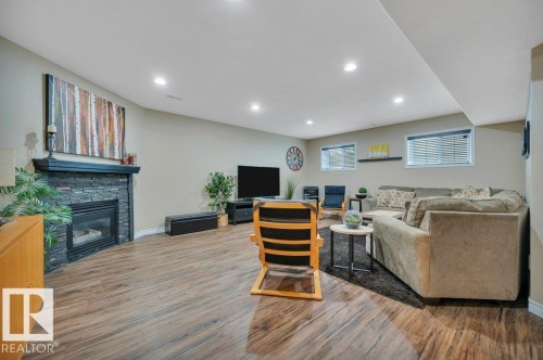 6909 159A Avenue Nw, Edmonton, AB - Indoor Photo Showing Basement With Fireplace