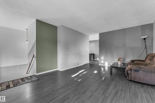Wood-finish flooring throughout the main living space - 3425 48 Street Nw, Edmonton, AB - Indoor
