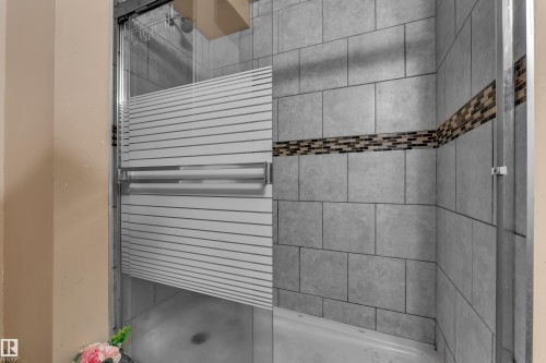 Shower enclosure with a sliding glass door and a rectangular shower base - 3425 48 Street Nw, Edmonton, AB - Indoor Photo Showing Bathroom