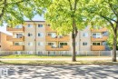 Multi-story building exterior with individual balconies, white framed windows, and a neutral-toned facade - #106 10620 104 St Nw, Edmonton, AB  - Outdoor 