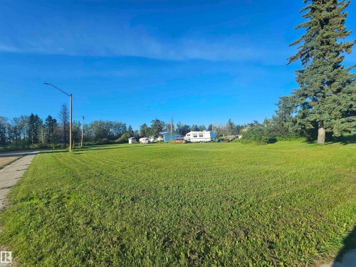 Expansive grassy area with a paved border, - 4832 52 Avenue, Wildwood, AB 