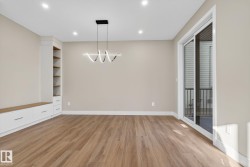 Built-in cabinetry with wood-finish shelving, contemporary pendant lighting, recessed ceiling lights, wood-finish flooring, and sliding glass doors - 