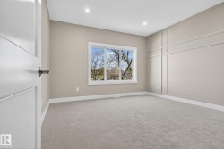 Neutral wall paint, recessed lighting, white trim, sliding window, and accent wall paneling - 