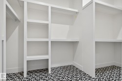 Built-in shelving units, integrated hanging rods, and patterned floor tile - 