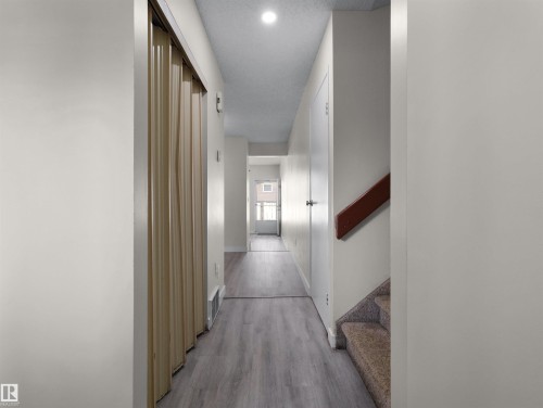 Hallway with wood-finish flooring, recessed lighting, and a neutral color palette - #47 1904 48 St Nw, Edmonton, AB - Indoor Photo Showing Other Room