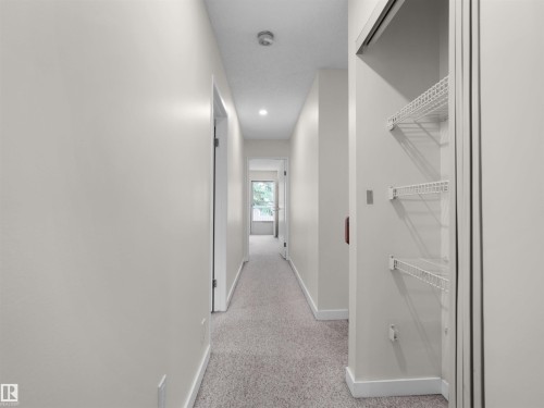 Hallway featuring neutral wall color, recessed lighting, and carpeted flooring - #47 1904 48 St Nw, Edmonton, AB - Indoor