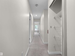 Hallway featuring neutral wall color, recessed lighting, and carpeted flooring - 