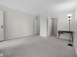 Carpeted flooring, white walls, and white trim - 