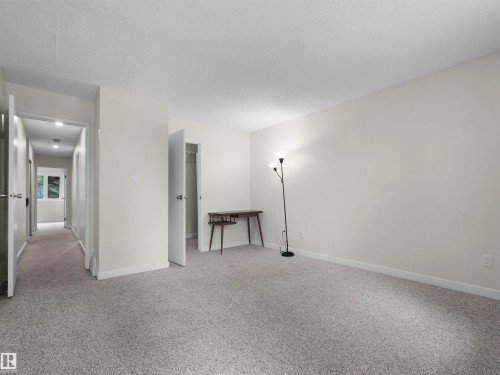 Neutral-toned walls complement the light grey carpeting - #47 1904 48 St Nw, Edmonton, AB - Indoor Photo Showing Other Room