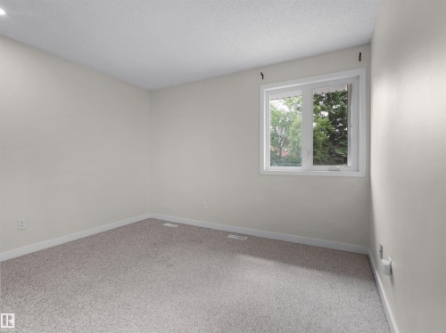 Neutral wall paint, light-colored carpeting, and a white-framed window - #47 1904 48 St Nw, Edmonton, AB - Indoor Photo Showing Other Room