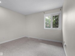 Neutral wall paint, light-colored carpeting, and a white-framed window - 