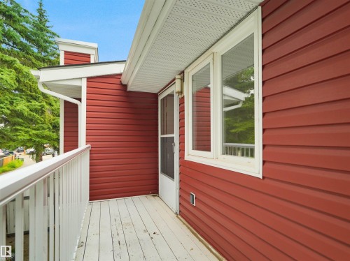 Outdoor balcony with white railing, red horizontal siding, and white window trim - #47 1904 48 St Nw, Edmonton, AB - Outdoor With Balcony With Exterior