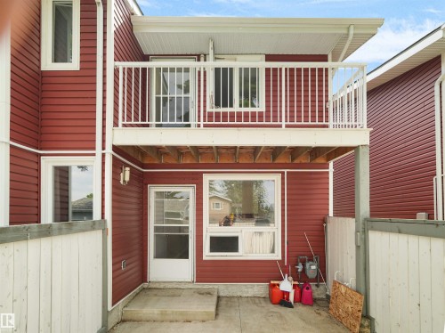 Red horizontal siding exterior with a white railed balcony - #47 1904 48 St Nw, Edmonton, AB - Outdoor With Balcony With Exterior