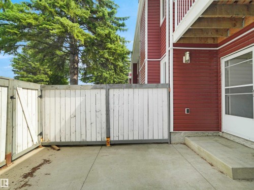 Enclosed concrete patio with a privacy fence and direct exterior access - #47 1904 48 St Nw, Edmonton, AB - Outdoor With Exterior
