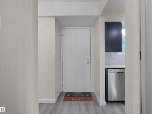 Light-toned walls with wood-finish flooring - #47 1904 48 St Nw, Edmonton, AB - Indoor Photo Showing Other Room