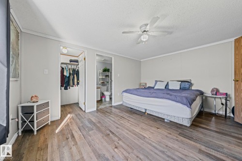Wood-finish flooring, light gray walls, white trim, and a ceiling fan with integrated lighting - 89 Springfield Crescent, Spruce Grove, AB 