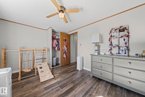 Wood-finish flooring, ceiling fan with light fixture, and closet with bi-fold door - 89 Springfield Crescent, Spruce Grove, AB 