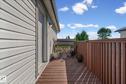 Outdoor wood-finish deck with a high privacy fence - 89 Springfield Crescent, Spruce Grove, AB 