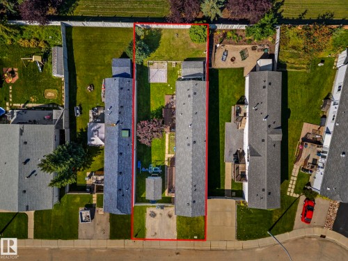 Expansive property featuring a rectangular lot, mature trees, and a spacious backyard with a patio area - 89 Springfield Crescent, Spruce Grove, AB 