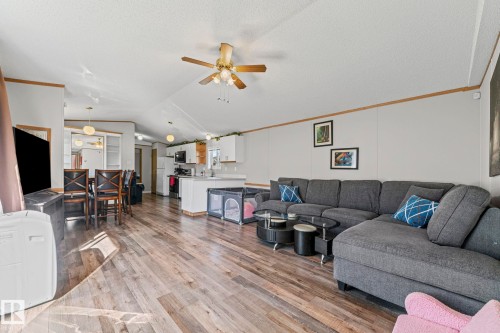 Open concept living space featuring wood-finish flooring, a ceiling fan, and recessed lighting - 89 Springfield Crescent, Spruce Grove, AB 
