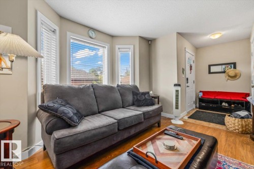 Wood-finish flooring throughout - 11436 88 Street Nw, Edmonton, AB - Indoor Photo Showing Living Room