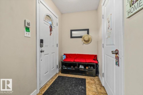White paneled doors with hardware and security keypad - 11436 88 Street Nw, Edmonton, AB - Indoor Photo Showing Other Room