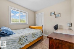 Neutral wall paint, white window trim, white interior door, and textured carpeting - 