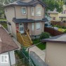 Two-story residence with light brown siding and a dark shingle roof - 11436 88 Street Nw, Edmonton, AB 
