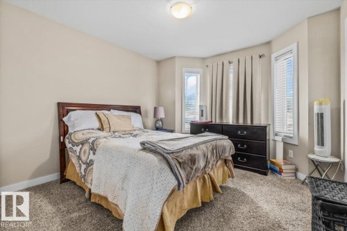 Neutral wall tones, carpeted flooring, built-in ceiling light, and multiple windows with blinds - 11436 88 Street Nw, Edmonton, AB - Indoor Photo Showing Bedroom