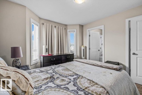 Neutral painted walls with recessed bay windows, integrated ceiling light fixture, and an interior door - 11436 88 Street Nw, Edmonton, AB - Indoor Photo Showing Bedroom