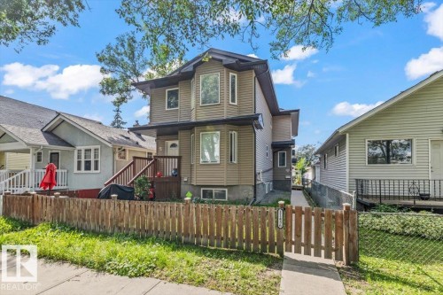 Multi-level home with bay windows, siding exterior, and a wooden privacy fence - 11436 88 Street Nw, Edmonton, AB - Outdoor