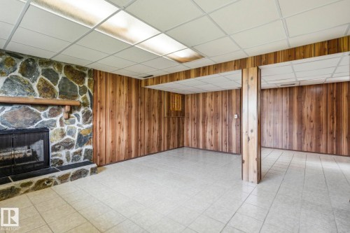 Natural stone fireplace with a wood mantel - 10007 168 Avenue Nw, Edmonton, AB - Indoor With Fireplace