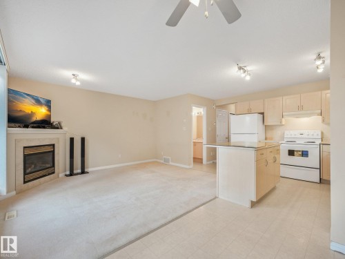 1142 Barnes Way Sw, Edmonton, AB - Indoor Photo Showing Kitchen With Fireplace