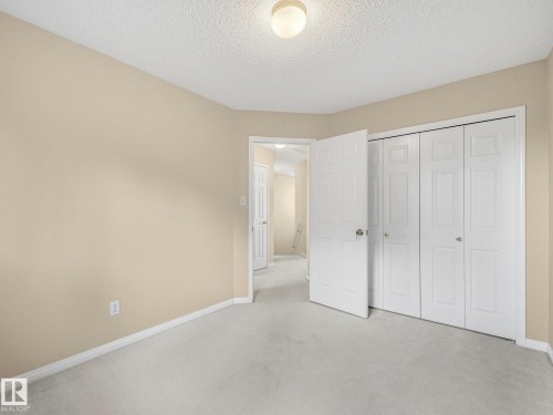 Neutral tone walls complement the light-colored carpeting - 1142 Barnes Way Sw, Edmonton, AB - Indoor Photo Showing Other Room