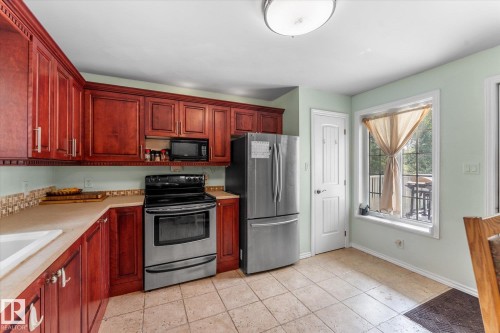 open to the dining area with back slider door to rear deck out tot ground level back yard - 2, 59031 Range Rd 232, Rural Thorhild County, AB - Indoor Photo Showing Kitchen
