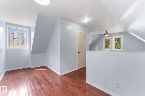 Angled ceiling lines with recessed lighting, wood-finish flooring, multiple windows, and a ceiling fan - 2, 59031 Range Rd 232, Rural Thorhild County, AB - Indoor Photo Showing Other Room