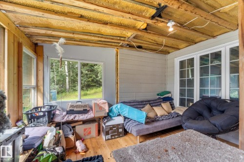 This sun room as added to the exterior of the home by the owner at that time the upper front deck was extend to cover this space it is not included in the sq footage of the home - 2, 59031 Range Rd 232, Rural Thorhild County, AB - Indoor