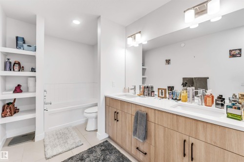 Dual vanity with integrated sinks and white countertops - 3236 Chernowski Way Sw, Edmonton, AB - Indoor Photo Showing Bathroom