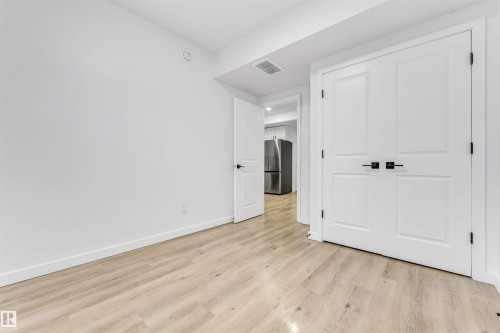Basement (Room 2): Light wood-finish flooring with white walls and trim - 3236 Chernowski Way Sw, Edmonton, AB - Indoor Photo Showing Other Room