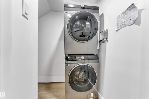 Stackable washer and dryer unit in the basement - 3236 Chernowski Way Sw, Edmonton, AB - Indoor Photo Showing Laundry Room