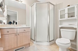 Light wood-finish vanity with countertop, built-in sink, and mirror - 
