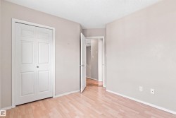 Wood-finish flooring with white trim and a neutral paint palette - 