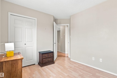 Wood-finish flooring with neutral wall tones and a ceiling-mounted light fixture - 204 84 Street Sw, Edmonton, AB - Indoor