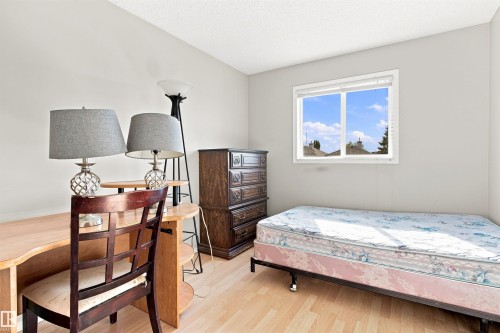 Light-toned wood-finish flooring, white walls, and a single window with white trim - 204 84 Street Sw, Edmonton, AB - Indoor Photo Showing Bedroom