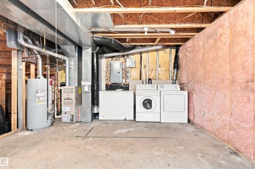 Laundry appliances with a chest freezer, exposed structural beams, and utility systems - 204 84 Street Sw, Edmonton, AB - Indoor Photo Showing Laundry Room