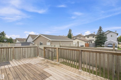 Spacious wood deck with perimeter railing and steps, overlooking a fenced yard - 204 84 Street Sw, Edmonton, AB - Outdoor With Deck Patio Veranda With Exterior